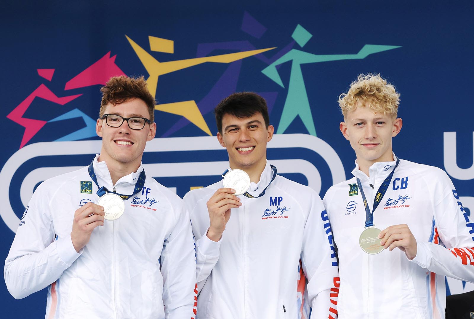Myles Pillage, Joe Choong and Charlie Brown holding silver medals