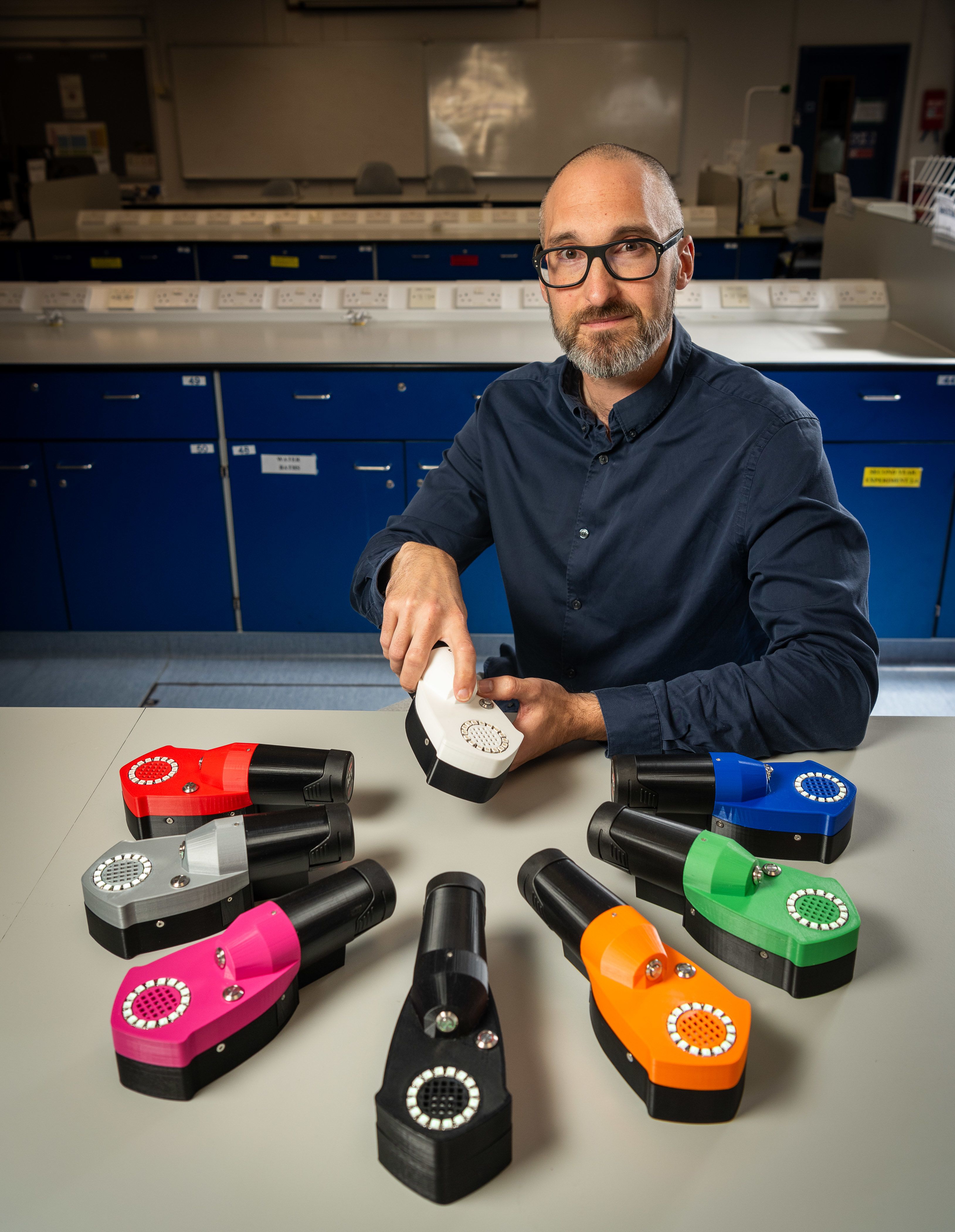 Professor Chris Pudney holding the spice detection device