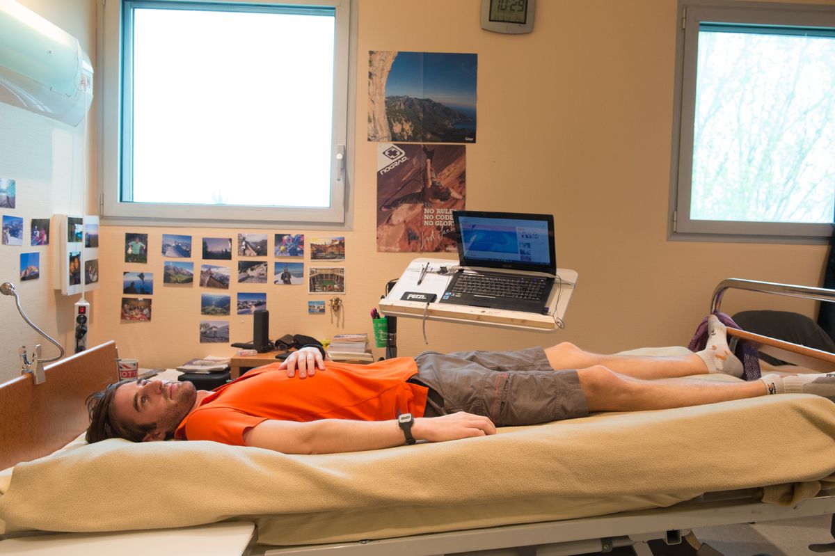 Man lying in bed with legs elevated