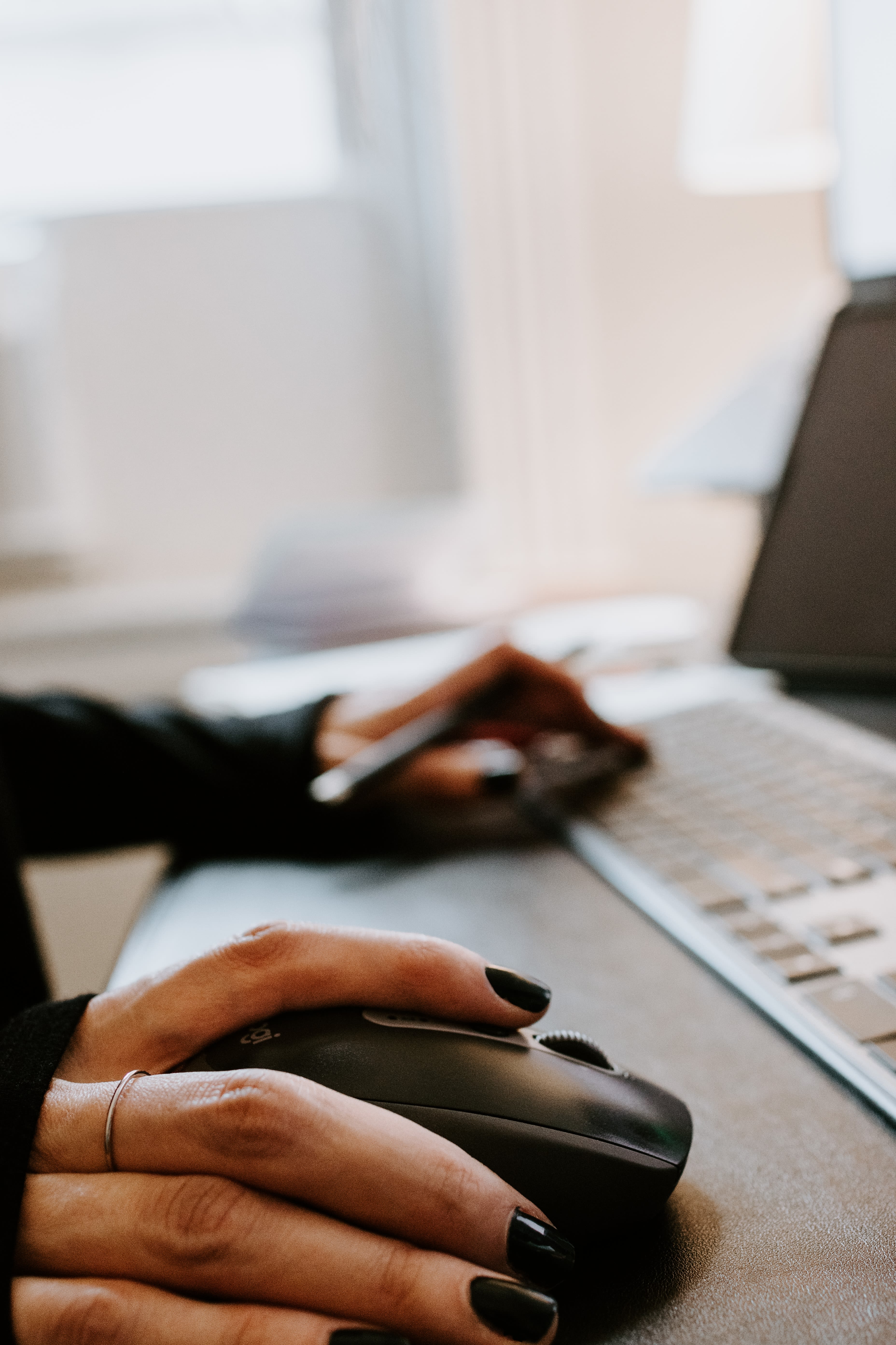 Person using black computer mouse