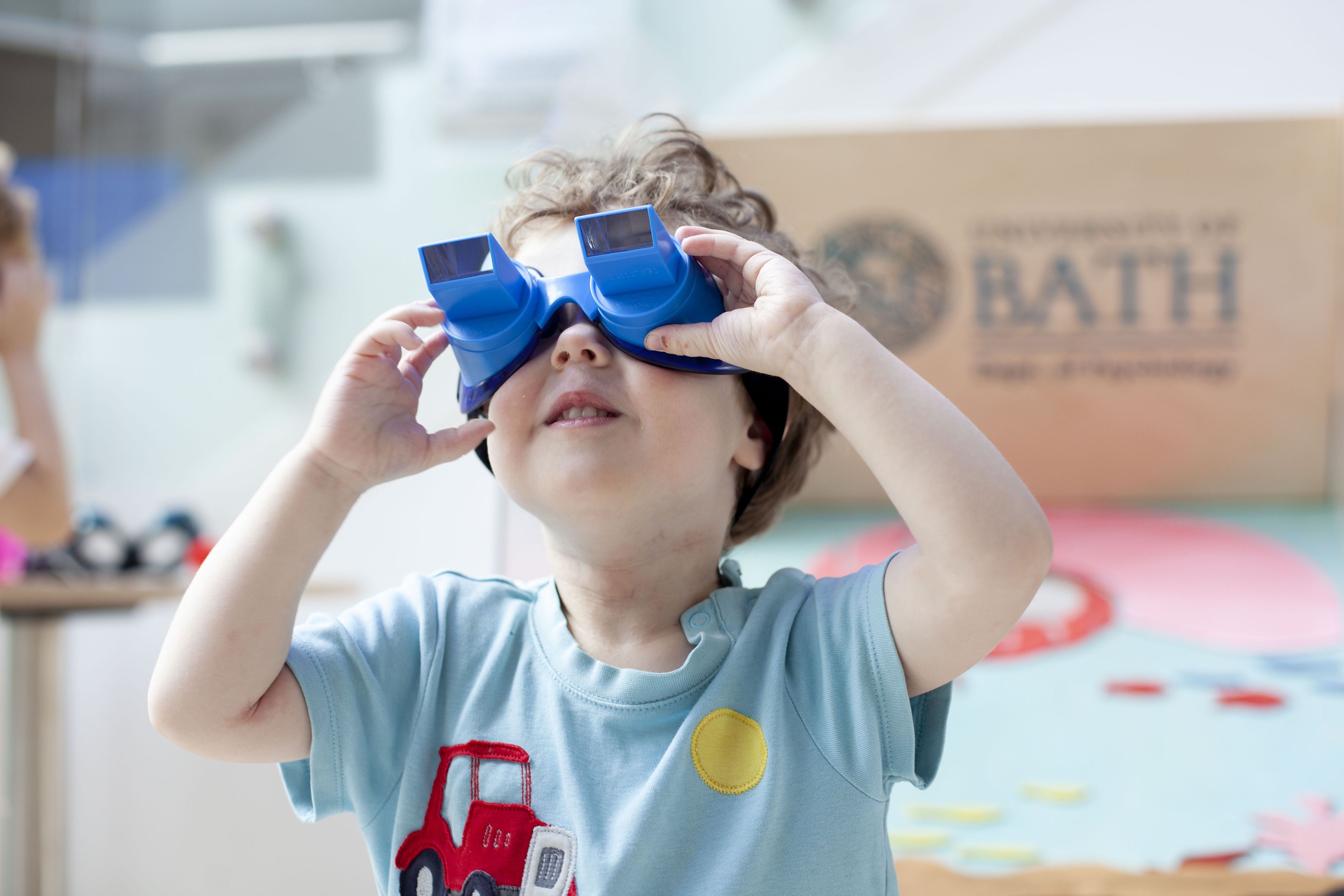 Toddler using blue plastic prism glasses