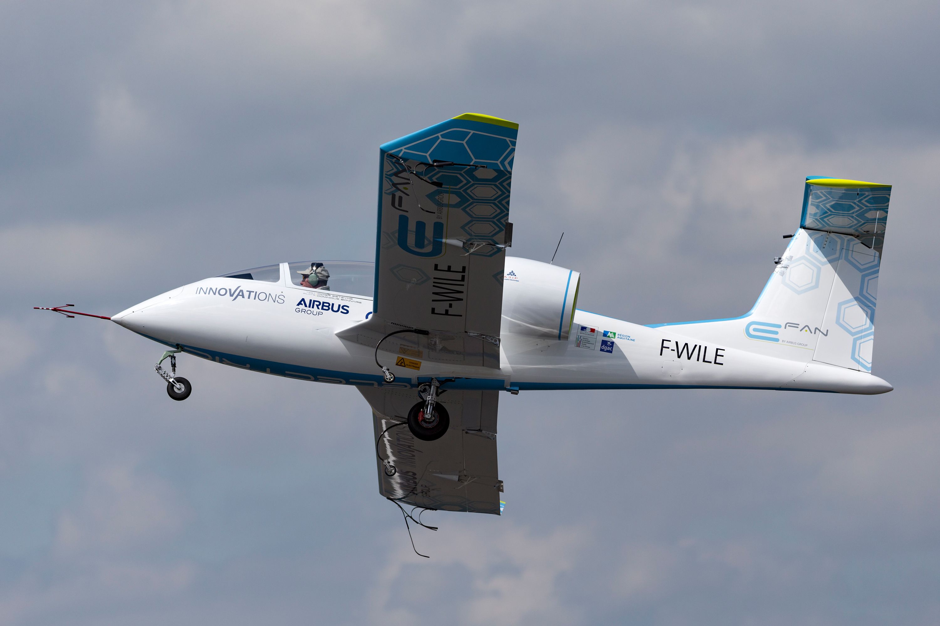 A shot of a small single passenger electric plane flying
